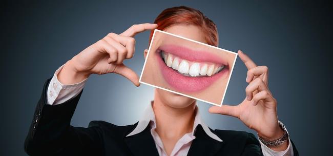 Teeth image being held up