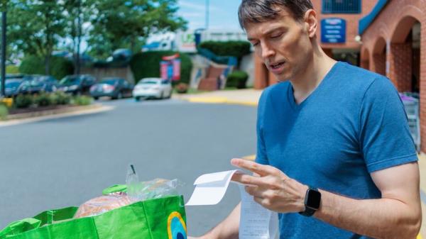 Man looks at receipt