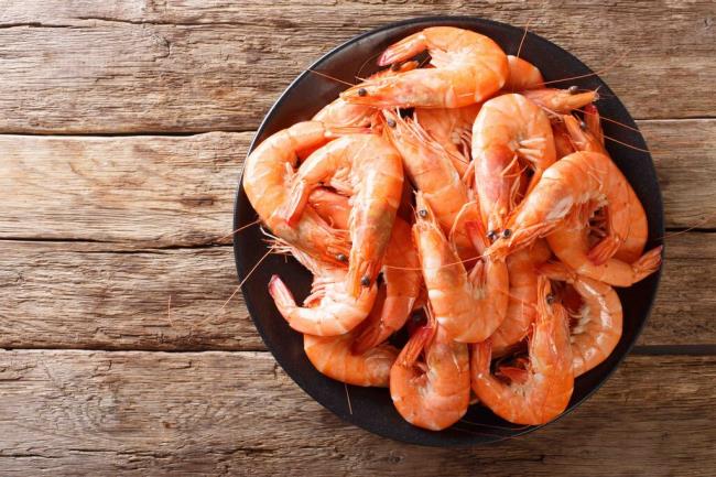 Healthy diet food: boiled wild tiger shrimps close-up on a plate on a table. Horizo<em></em>ntal top view