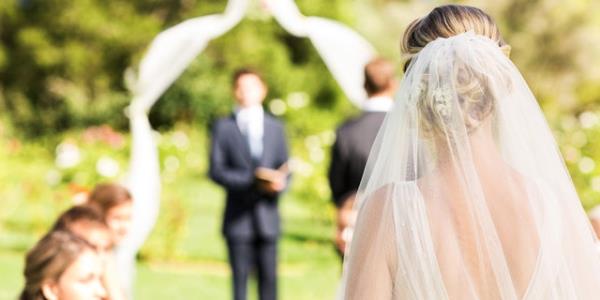 Bride walks down aisle.