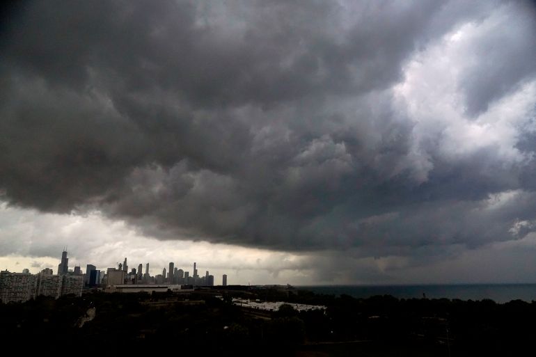 Heavy rain clouds gather over the skyline of Chicago and Lake Michigan.