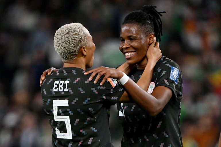 Nigeria's o<em></em>nome Ebi and Osinachi Ohale celebrate after the match