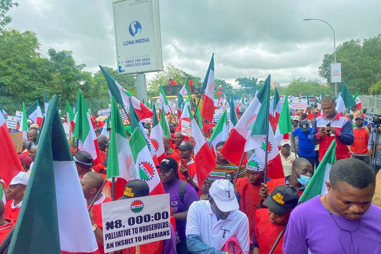 Members of the Nigerian Labour Unio<em></em>n, holding flags and placards, march during a protest against fuel price hikes and rising costs, in Abuja, Nigeria August 2, 2023.