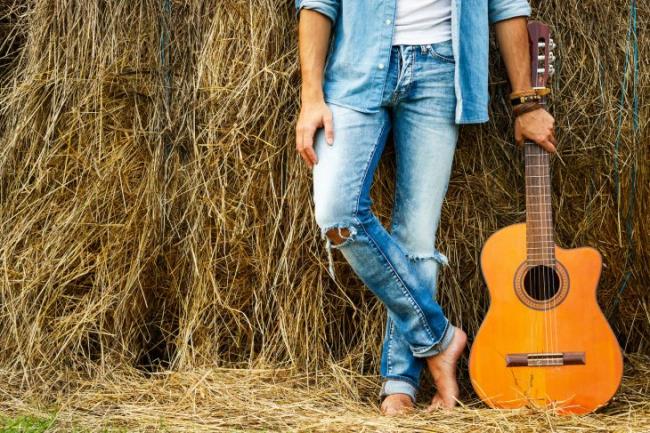 man holding acoustic guitar