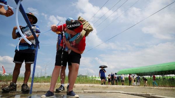 A participant drinks water at a water supply zone of the camping site for the 25th World Scout Jamboree in Buan, South Korea, August 4, 2023. REUTERS/Kim Hong-Ji TPX IMAGES OF THE DAY
