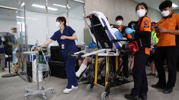 A participant is carried on a stretcher at Jamboree Hospital during the 25th World Scout Jamboree in Buan, South Korea, August 4, 2023. REUTERS/Kim Hong-Ji
