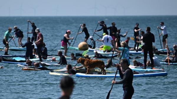 Surfers take part in a mass protest, organised by Ocean Charity Surfers, to demo<em></em>nstrate against the co<em></em>ntinued dumping of untreated sewage by water companies off the coast of Brighton, Britain, May 20, 2023. REUTERS/Dylan Martinez