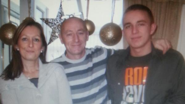 Carl with his mum Marie and dad Kenny. Pic: Merseyside Police