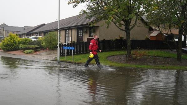 Emergency services go door to door speaking with residents in Inverurie, Aberdeenshire as Storm Babet batters the country and a rare red weather warning is in place for parts of eastern Scotland all day on Saturday. Picture date: Saturday October 21, 2023.