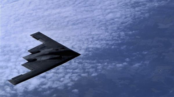 B-2 bomber in flight over clouds