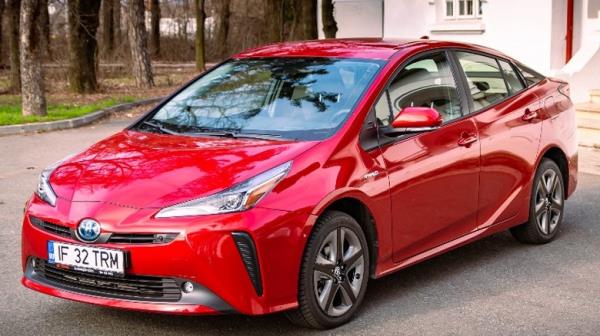 Red Prius parked driveway