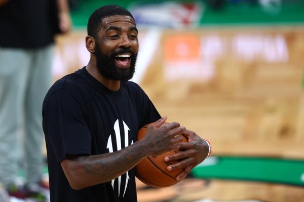 Kyrie Irving is all smiles during a Mavericks workout on Media Day ahead of the NBA Finals against the Celtics.