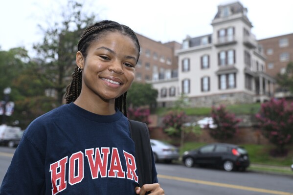 Howard University student Nikkya Taliaferro poses for a portrait across the street from her school, Friday, Aug. 30, 2024 in Washington. (AP Photo/John McDonnell)