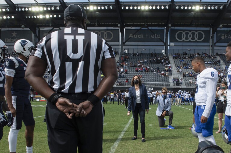 Vice President Kamala Harris takes part in the ceremo<em></em>nial coin toss before an NCAA college football game between Howard and Hampton in Washington, Sept. 18, 2021. (AP Photo/Cliff Owen, File)