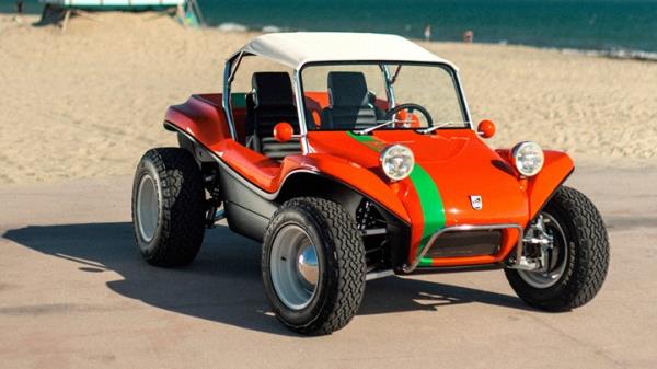 Meyers Manx 2.0 EV - front, red with white Bimini roof and green stripe, on beach