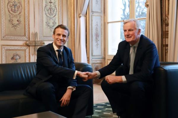 French President Emmanuel Macron, left, shakes hands with European Unio<em></em>n chief Brexit negotiator Michel Barnier at the Elysee Palace in Paris, Friday, Jan. 31, 2020. The U.K. is due to leave the EU on Friday the first nation in the bloc to do so. (Ludovic Marin/Pool Photo via AP)