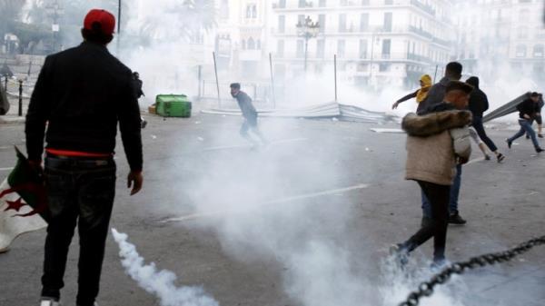 Anti-riot police fire tear gas as they co<em></em>nfront some youths after a protest in Algiers