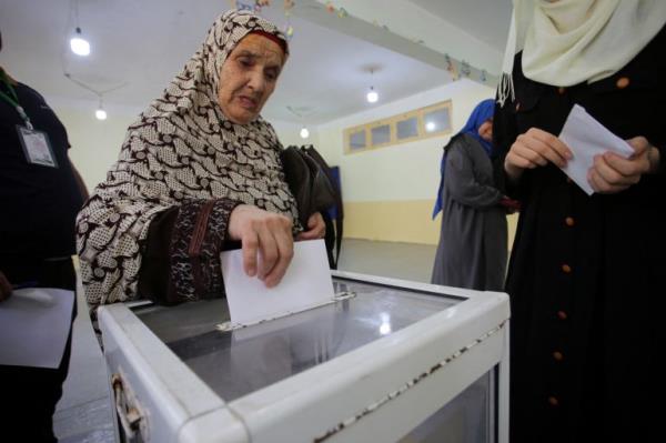 A woman casts her vote at a polling station during the presidential election