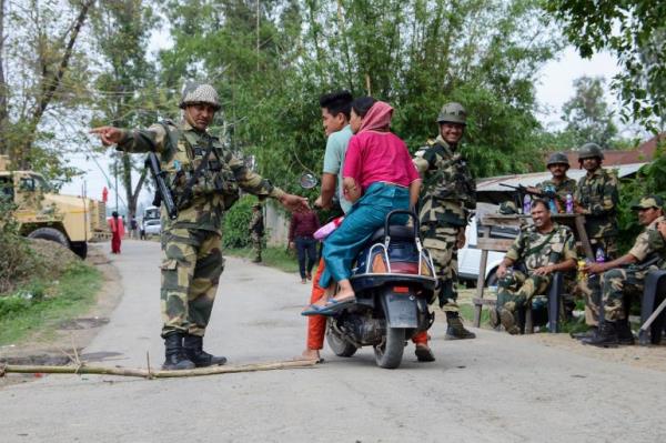 A paramilitary soldier stops a vehicle from entering a polling booth area during a re-polling in Imphal West District, Manipur, India, Monday, April 22, 2024. Voters at some polling places in this northeastern state went back to the polls amid tight security on Mo<em></em>nday after violence disrupted the vote last week. (AP Photo/Bullu Raj)