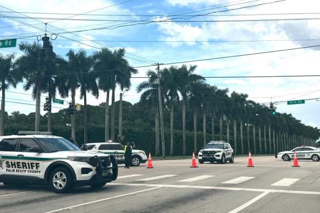 Police cars cordon off an intersection.