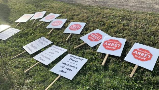 Picket signs lie on the ground.