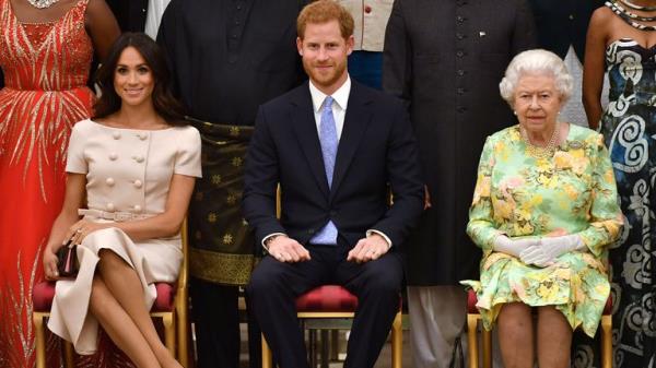 Queen Elizabeth, Prince Harry and Meghan, the Duchess of Sussex pose for a picture with some of Queen's Young Leaders at a Buckingham Palace reception following the final Queen's Young Leaders Awards Ceremony 2018