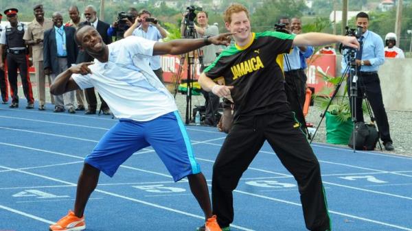 Britain's Prince Harry, right, and Olympic sprint champion Usain Bolt pose for photographers doing Bolt's landmark gesture after a mock race in Kingston, Jamaica, Tuesday March 6, 2012. The Prince is in Jamaica as part of the Diamond Jubilee tour in ho<em></em>nor of Queen Elizabeth II who celebrates 60 years on the throne. His visit comes as the new prime minister, Portia Simpson Miller, has called anew for the severing of ties with the British monarchy. (AP Photo/Collin Reid)