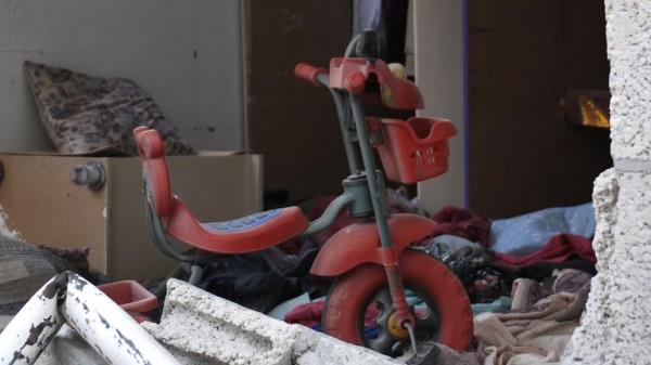 A lone tricycle was visible in the remains of one home 