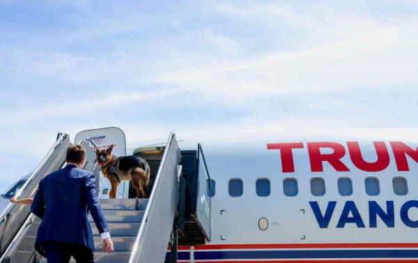 Atlas, J.D. Vance’s dog, boards a plane to join his owner on the campaign trail.