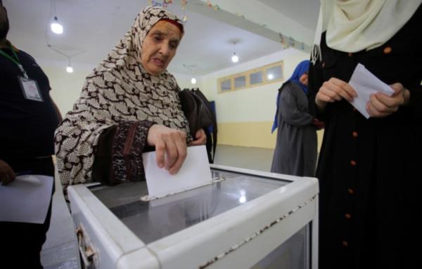 A woman casts her vote at a polling station during the presidential election