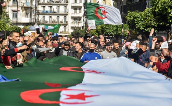 Algerians wave natio<em></em>nal flags during an anti-government protest in the capital Algiers on March 5, 2021. - Thousands of people demo<em></em>nstrated in Algiers and other cities across the country, co<em></em>nfirming the remobilization of the Hirak protest movement again in the streets since the second anniversary of the uprising on February 22. (Photo by RYAD KRAMDI / AFP)