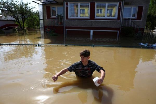 A person walks through floodwater