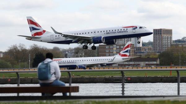 People watch as a British Airways Embraer E190SR takes off from Lo<em></em>ndon City Airport in London, Britain, April 11, 2024. REUTERS/Isabel Infantes