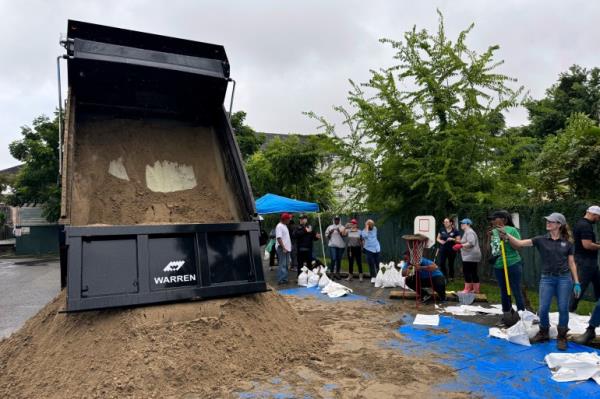 Residents fill up sand bags to protect their homes in anticipation of Tropical Storm Francine