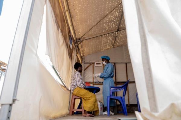 A health worker attends to a mpox patient, at a treatment centre in Munigi, eastern Congo, Monday, Aug. 19, 2024 