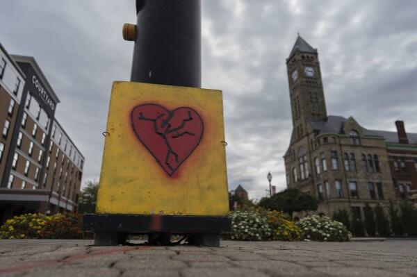 An image of a broken heart is fixed across the street from City Hall with the Heritage Center of Clark County, right, Tuesday, Sept. 17, 2024, in Springfield, Ohio. (AP Photo/Carolyn Kaster)