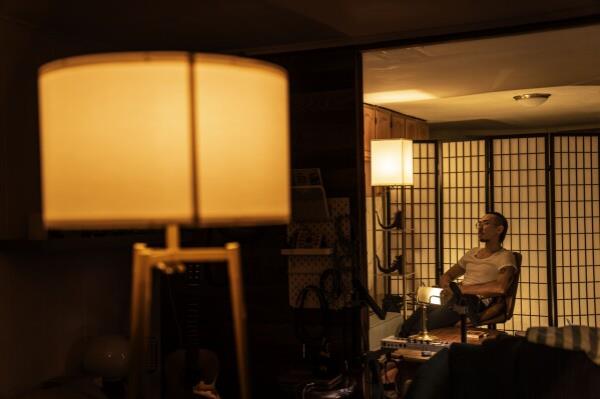 Robert Calabretta, who was adopted as a baby out of South Korea to an American family, sits in his apartment, Thursday, Feb. 15, 2024, in New York. (AP Photo/David Goldman)