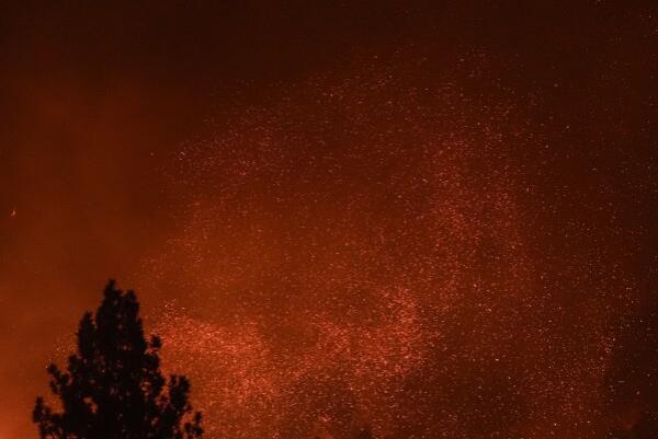 Embers fly through the smoky air as the Bridge Fire burns in Wrightwood, Calif., Wednesday, Sept. 11, 2024. (AP Photo/Jae C. Hong)