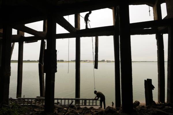 Co<em></em>nstruction workers take advantage of the record-low water level of the Paraguay River to repair the foundation of the port in Asuncion, Paraguay, Thursday, Sept. 12, 2024. (AP Photo/Jorge Saenz)