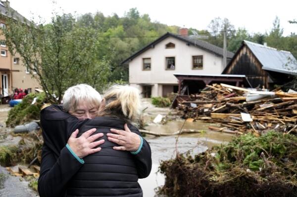 A resident hugs her relative after being evacuated from her flooded house in Jesenik, Czech Republic, Sunday, Sept. 15, 2024. (AP Photo/Petr David Josek)