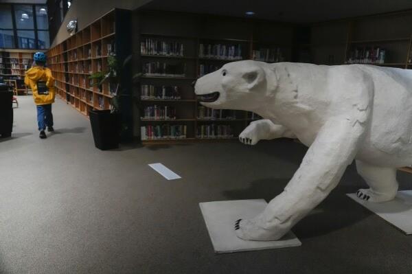 A polar bear sculpture greets patrons, Wednesday, Aug. 7, 2024, at the Churchill Public Library in Churchill, Manitoba. (AP Photo/Joshua A. Bickel)