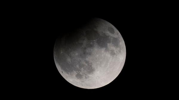 A partial eclipse darkens a rising supermoon in Nashville, Tennessee