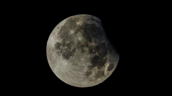 A supermoon with a partial solar eclipse rises over Brandenburg, Biegen, Germany. Pic: AP