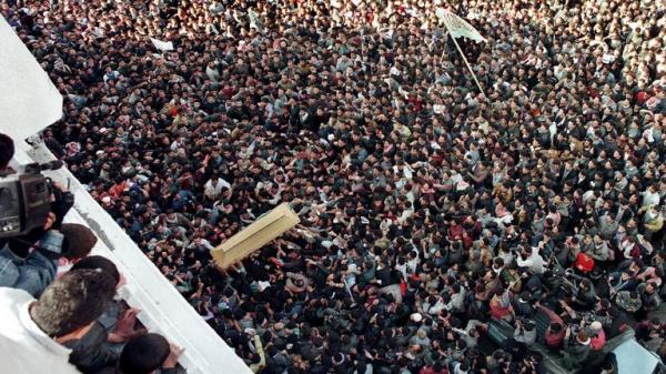 The coffin of Yahya Ayyash is carried into the Palestine mosque for funeral services January 6 as the crowd of Hamas movement supporters rushes to touch the plain wooden coffin. Ayyash, known as "The Engineer", was killed yesterday when a booby-trapped cellular telephone exploded. He was respo<em></em>nsible for the death of dozens of Israelis in suicide bombings and topped Israel's most-wanted list. Tens of thousands of Palestinians turned out for his funeral and vowed revenge against Israel