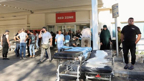 People gather outside a hospital in Beirut to check on the injured. Pic: Reuters