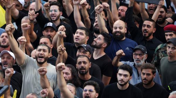 Men react as they attend the funeral for people who were killed amid the deto<em></em>nation of pagers across Lebanon, in Beirut, Lebanon September 18, 2024. REUTERS/Mohamed Azakir