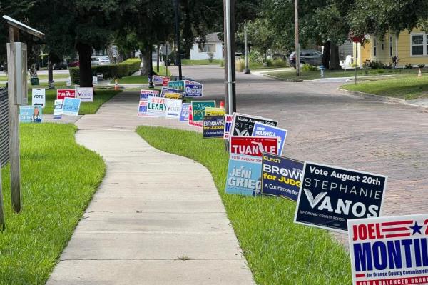 School board primary candidate signs outside a polling place in Orlando, Florida, August 20, 2024. 