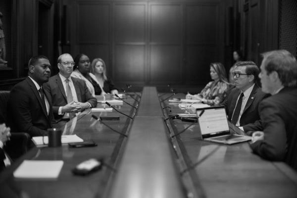 black and white image of Michael Regan in a meeting at the EPA Headquarters