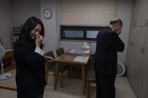 Adoptee Nicole Motta, left, and her birth father, Jang Dae-chang, wipe tears after an emotio<em></em>nal reunio<em></em>n at the Eastern Social Welfare Society in Seoul, Friday, May 31, 2024. The moment they hugged, Motta, adopted to the United States in 1985, didn't need DNA test results, she knew she'd come from this man. "I am a sinner for not finding you," he said. "I think I have your nose," Motta said softly. They both sobbed. (AP Photo/Jae C. Hong)