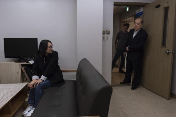 Nicole Motta, left, turns to see her birth father, Jang Dae-chang, as he enters the room at the Eastern Social Welfare Society in Seoul, South Korea, Friday, May 31, 2024, as they're reunited for the first time since she was adopted in 1985 by a family in Alabama. (AP Photo/Jae C. Hong)